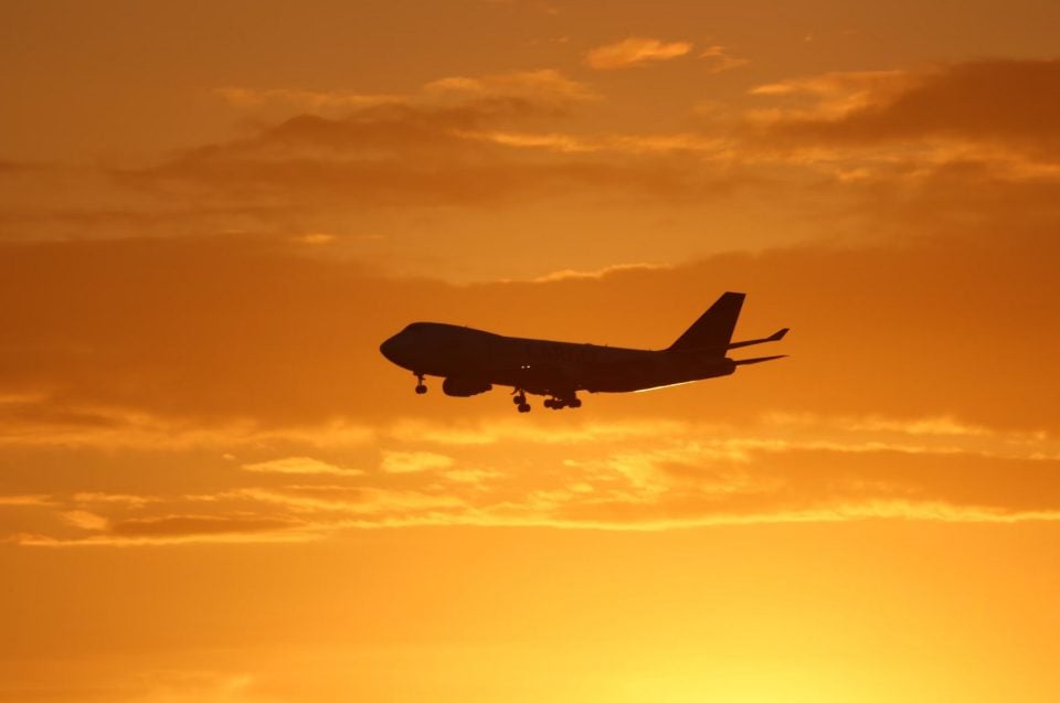 Airplane against sunset