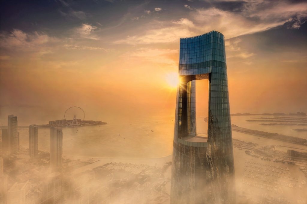 Exterior sunset view of Ciel Tower Dubai showing the signature Sky Portal and observation deck